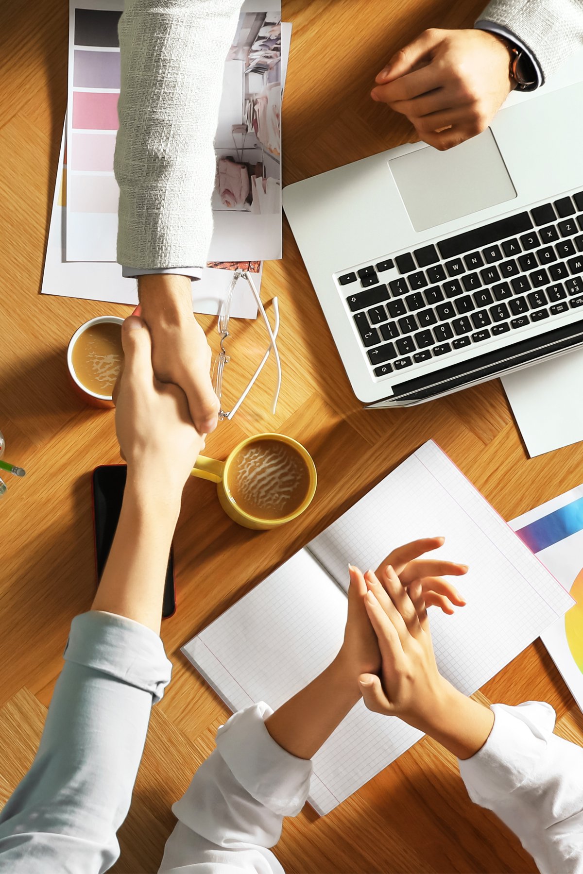 alt="Interior Designers Shaking hands across a table"
